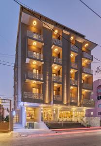 a large apartment building with balconies on a street at Regenta Inn Grand-ORR, Mahadevapura in Bangalore