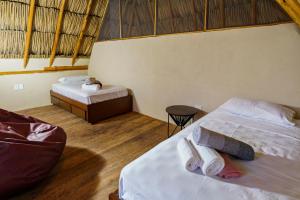 a bedroom with two beds and a table and a tableasteryasteryasteryasteryastery at Casa Mambo Salinas in Santa Veronica +53 photos