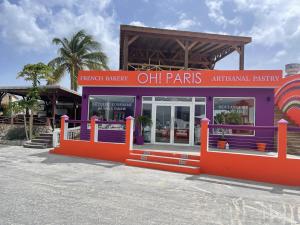 a restaurant with an orange and purple building at Maho Beach House - Spacious 1 Bedroom Suite in Maho Reef