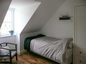 a bedroom with a bed in a attic at Sqlarran Cottage in Lochranza