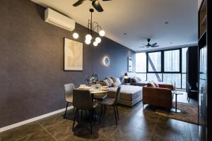 a living room with a table and a couch at Scarletz KLCC Studio Suites 4 pax Luxury Modern Style WiFi 100Mbps in Kuala Lumpur