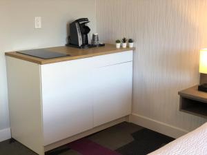 a white counter with a coffee maker on top of it at The Spot at Porpoise Bay in Sechelt