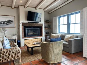 a living room with a couch and a fireplace at C'est la Vie in Paternoster