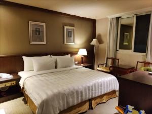 Voodi või voodid majutusasutuse Dahshin Hotel toas