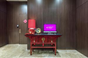 a desk with a computer on top of it at Ashley Tang Menteng Jakarta in Jakarta