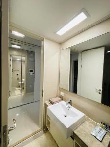 łazienka z umywalką i dużym lustrem w obiekcie Happy Days at Highvill G w mieście Promyshlennyy