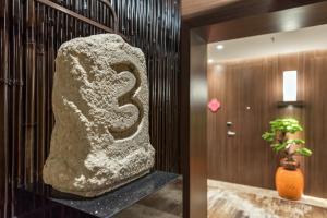 a large rock sitting on a shelf in a lobby at Ashley Tang Menteng Jakarta in Jakarta