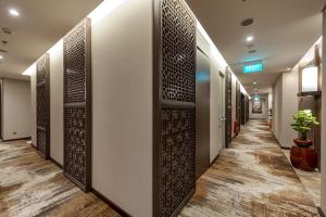 a corridor of a hospital hallway with a wall of doors at Ashley Tang Menteng Jakarta in Jakarta