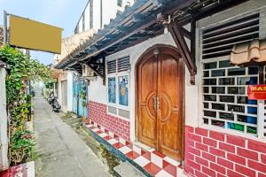 drewniane drzwi na boku budynku w obiekcie SPOT ON 91915 Homestay Superman w mieście Yogyakarta