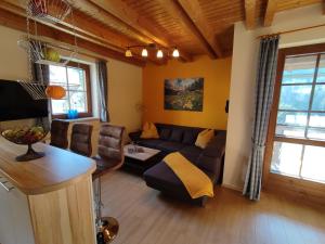 a living room with a couch and a table at Landhaus Seebacher in Spital am Pyhrn