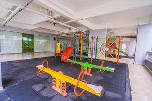 a gym with a play area with a playground at Cozy 2 bedroom w pool for 6 - Seri Kembangan in Seri Kembangan