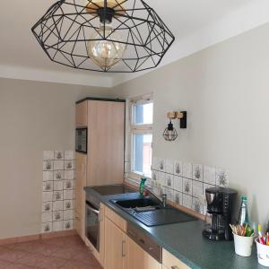 a kitchen with a sink and a ceiling at Ferienwohnung H2 am Hainich 