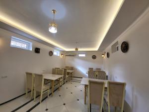 a dining room with tables and chairs and a ceiling at Ulli Oy Boutique & Terrace in Khiva