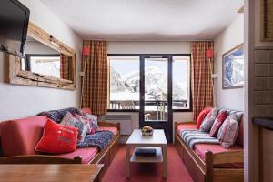 a living room with two couches and a table at Stylish modern apartment for 4 by Avoriaz Chalets in Avoriaz