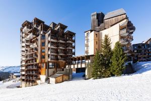 a building in the snow next to another building at Central modern Duplex for 6 by Avoriaz Chalets in Avoriaz