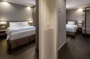 Postel nebo postele na pokoji v ubytování Ropewalk Piazza Hotel Managed by The Ascott Limited