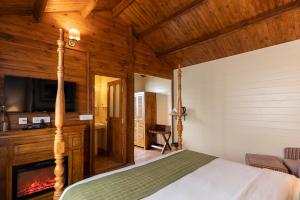 a bedroom with a bed and a fireplace at Larisa Resort, Mussoorie in Mussoorie