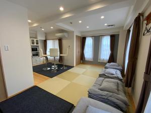 a living room with a couch and a table at オレンジの風 in Imabari