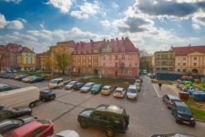 a parking lot with cars parked in front of buildings at Rynek Apartment The Heart of the City by Renters in Wrocław