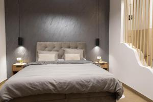 a bedroom with a large bed with two night stands at STUDIO APARTMAN BAROSSA in Vinkovci