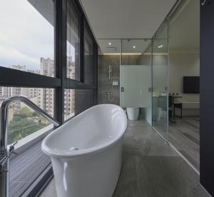 a bath tub in a bathroom with a large window at CP Hotel in Dayuan