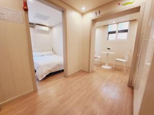 a bedroom with a bed and a table and a window at Olive hostel R(Residence) in Seoul