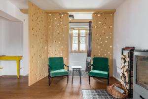 two chairs and a table in a living room at Hiša na soncu / Sun house in Zgornje Gorje