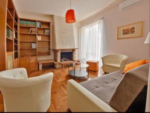 a living room with a couch and a fireplace at Key Apartment Vatican Wall in Rome