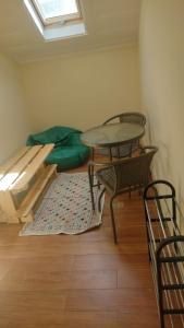 a room with a table and chairs and a bed at Sweet Love Family Budget in Coimbra