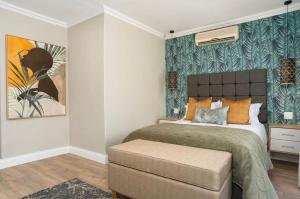 a bedroom with a bed and a painting on the wall at Carthews Luxury BnB in Queenstown