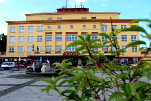 a yellow building with a clock tower on top of it at Mini Hotel Akord in Ostrava
