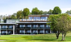 an apartment building with a tree in front of it at Ringenäs Hotell & Konferens in Halmstad