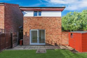 a brick house with a sliding glass door at Inviting 2-Bed House in Milton Keynes - Netflix in Milton Keynes