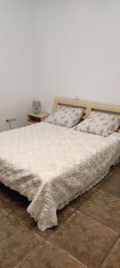 a bedroom with a large bed with white sheets and pillows at Гостевая комната in Chernivtsi