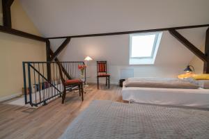 a attic bedroom with two beds and a window at Franze´s Haus - mit Rhein- & Burgenblick in Boppard