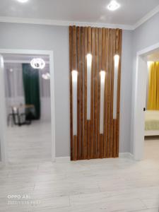 a room with a wooden door with lights on it at Мухтара Ауэзова 205 in Kokshetau