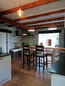 a kitchen with a table and chairs in a room at Knysna Tranquil 3 Bedroom Cabin in Knysna