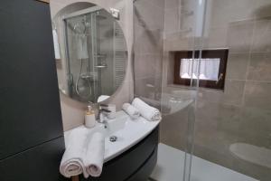 a bathroom with a sink and a shower with a mirror at APARTMENT GORDANA A4+2 FOR 6 PAX NATURE PARK in Lokve