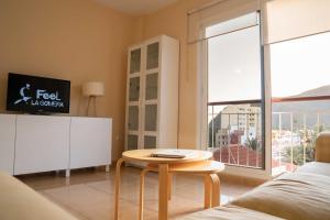 a living room with a table and a large window at Miramar 4 in San Sebastián de la Gomera