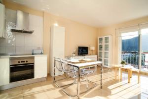 a kitchen with a table and chairs in a room at Miramar 4 in San Sebastián de la Gomera