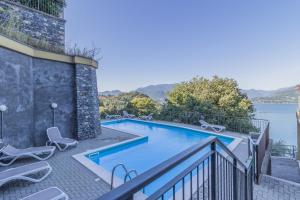 a swimming pool with a view of the water at Casa Andrea Varenna in Perledo +15 photos