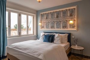 a bedroom with a large bed with blue and white pillows at Ca Maria Adele in Venice