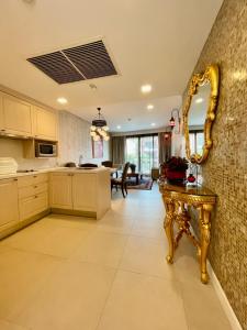 a kitchen with a gold mirror and a table at Baan Marakesh Hua Hin in Hua Hin