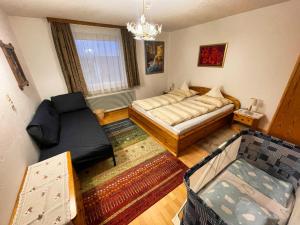 a living room with a bed and a couch at Panorama-Ferienwohnung Isser in Seefeld in Tirol