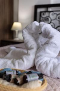 a towel on a bed next to a toy car at Ioannis Rooms Δωμάτια με θεα στη θαλασσα in Paránimfoi