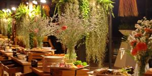a buffet line with plates of food and flowers at Vannee Golden Sands Beachfront Resort in Haad Rin