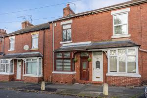 a red brick house with a white door at Stylish 3 Bedroom Central Property in Newcastle under Lyme