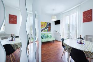 a room with a table and chairs and a living room at We Home - RICCIONE LOFT Altavilla in Riccione
