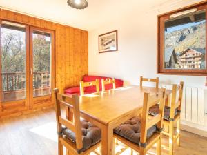 a dining room with a wooden table and chairs at Les Ecureuils - A09 - Appart Chaleureux - 6 pers in Saint-Sorlin-dʼArves