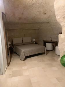 マテーラにあるアルベルゴ デル セディーレの石壁のベッドルーム1室